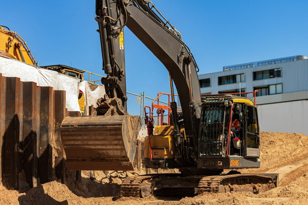 A construction site with a machine lifting a bucket